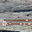 This Brown leather Western style hat band features Silver Longhorn Conchos with Silver bands separating them. It has a adjustable fit with a Star design western buckle closure. 