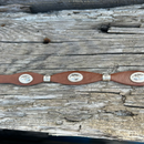 This Brown leather Western style hat band features Silver Longhorn Conchos with Silver bands separating them. It has a adjustable fit with a Star design western buckle closure. Close up view of Conchos. 