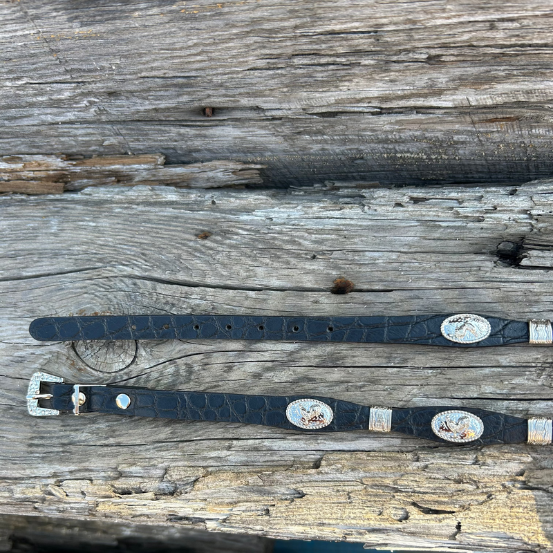 This Black leather western style hat band features Silver Rooster Conchos with Silver bands in between. It has a adjustable fit with a crystal studded western style buckle for closure. 