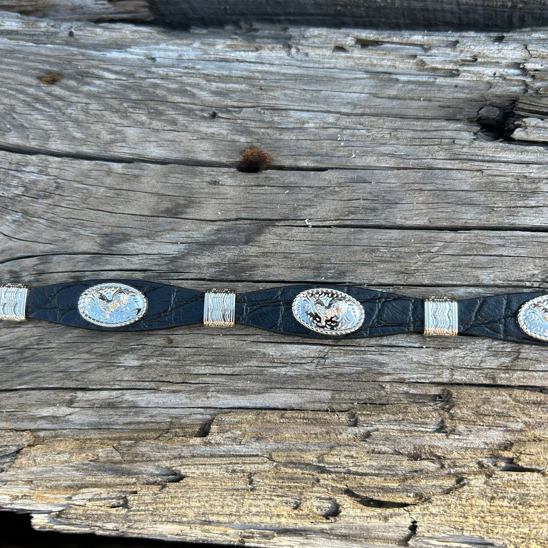 This Black leather western style hat band features Silver Rooster Conchos with Silver bands in between. It has a adjustable fit with a crystal studded western style buckle for closure. Close up view of Rooster Conchos and Silver Bands. 