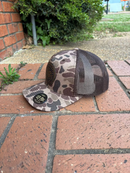 Leather circle patch with Mississippi Established 1817 and a bulldog on a old school brown camo Richardson 112PFP cap. Cap features a brown mesh back and is adjustable. Side view
