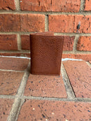 A pebbled brown leather trifold wallet.