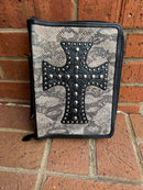 A snake print Bible cover with a studded cross on the front.