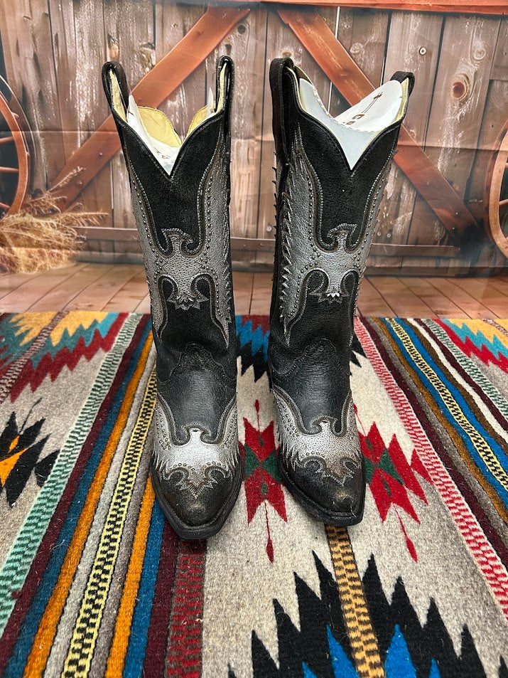 A black leather boot with a silver metallic eagle design on the side and a snip toe. Front View