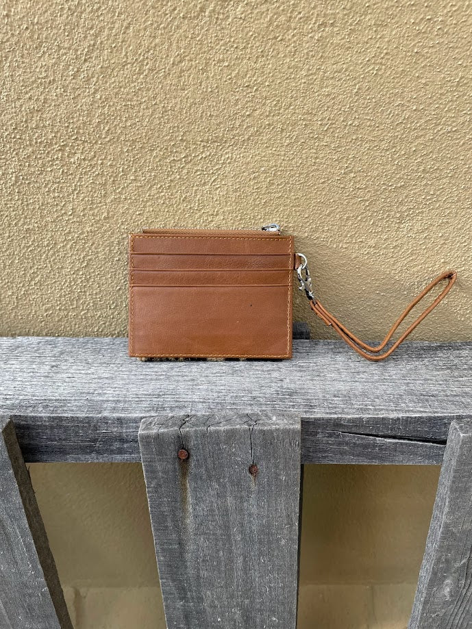This Brown leather and cowhide wristlet wallet features six total card slots and a zippered pocket. Rear view showing three card slots. 