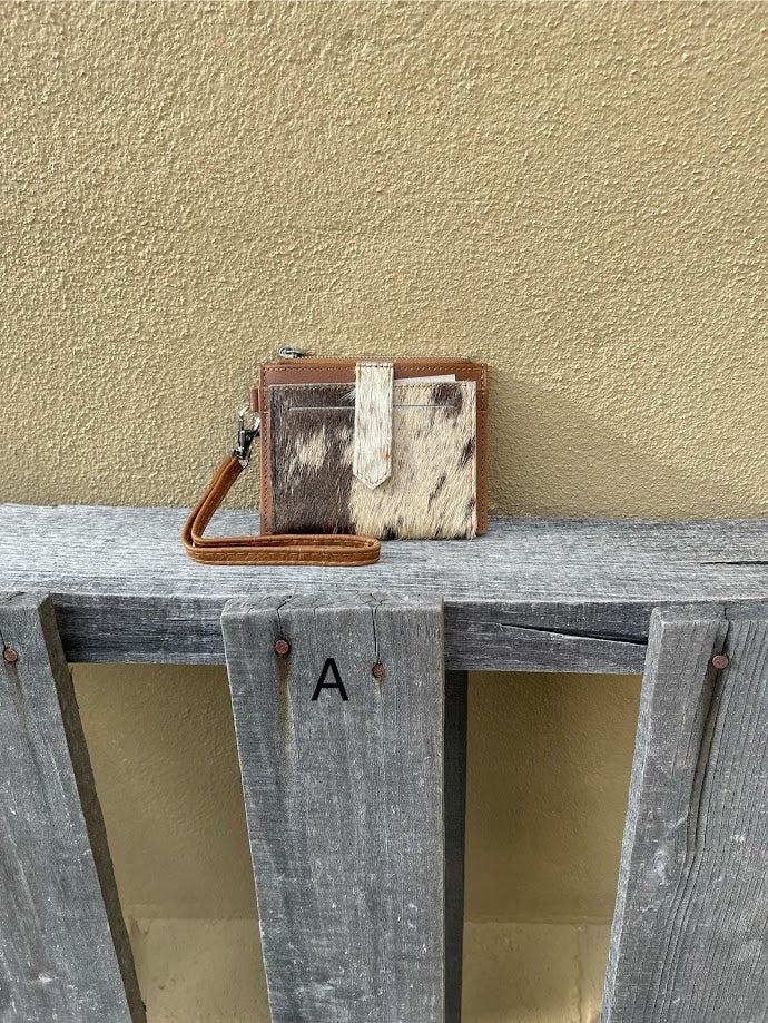 This Brown leather and cowhide wristlet wallet features six total card slots and a zippered pocket. Front View A