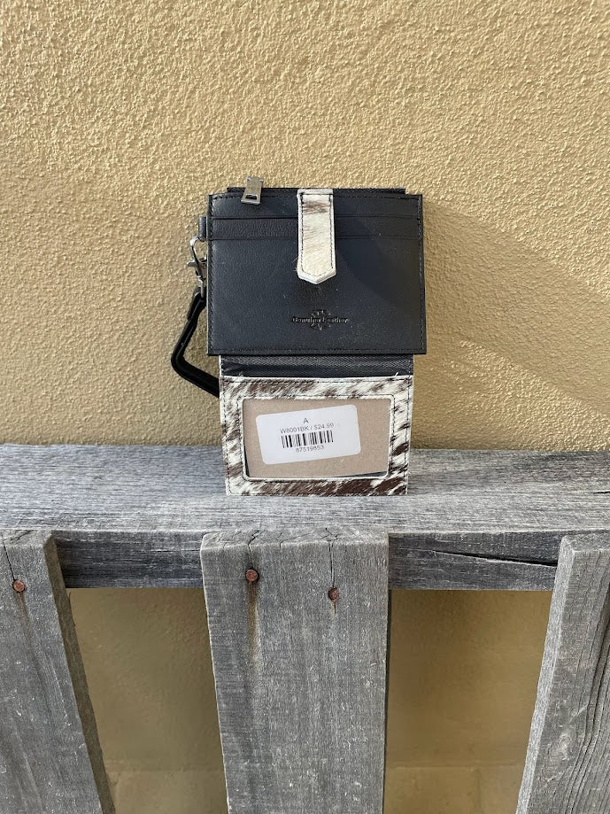 This black leather and cowhide wristlet wallet has six total card slots along with a zippered close pocket. Inside view showing three card slots and a ID window.  