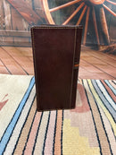 Brown leather checkbook wallet with an embossed praying cowboy design on top, and the bottom is basket weave featuring three hair- on crosses. Rear View