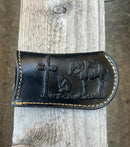 This Black leather knife sheath from Top Notch Accessories features an embossed Praying Cowboy design. Front View