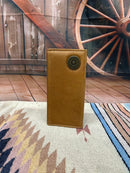 Brown leather tall wallet featuring a shotgun shell concho. Front View