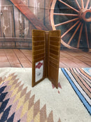 Brown leather tall wallet featuring a shotgun shell concho.  Inside View