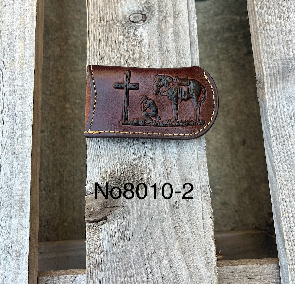 This Coffee Brown leather knife sheath features a embossed Praying Cowboy design. Front View