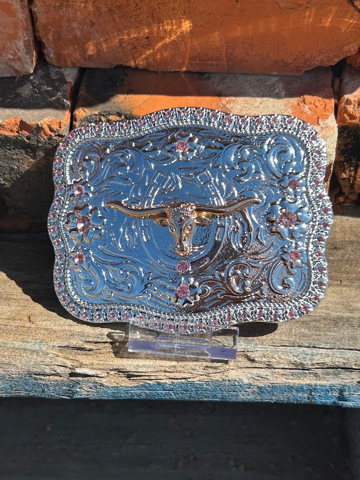 Silver buckle with Gold longhorn and a Pink rhinestone border. 
