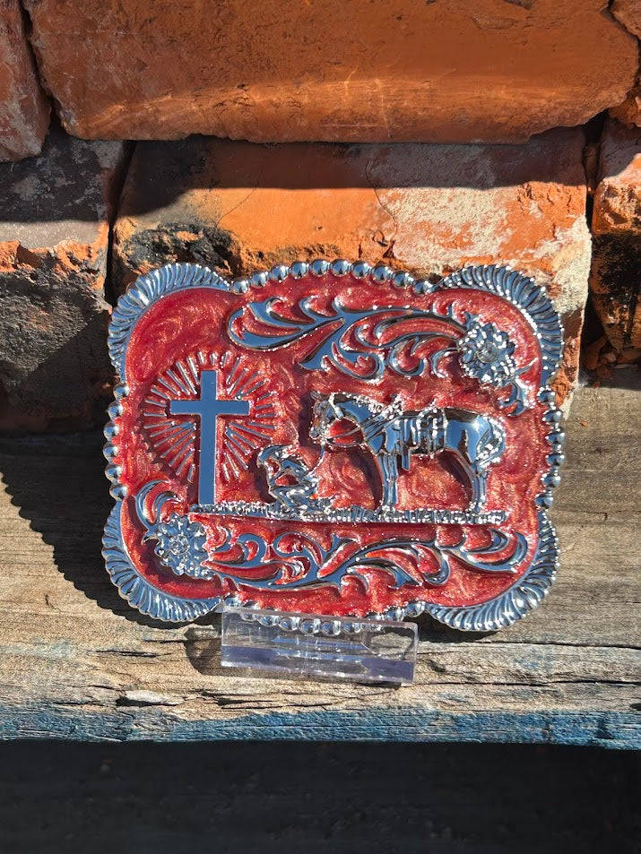 Silver Praying Cowboy belt buckle on a Clay background. 
