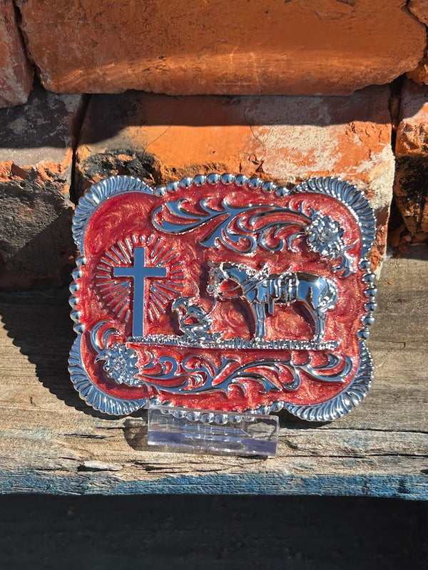 Silver Praying Cowboy belt buckle on a Clay background. 
