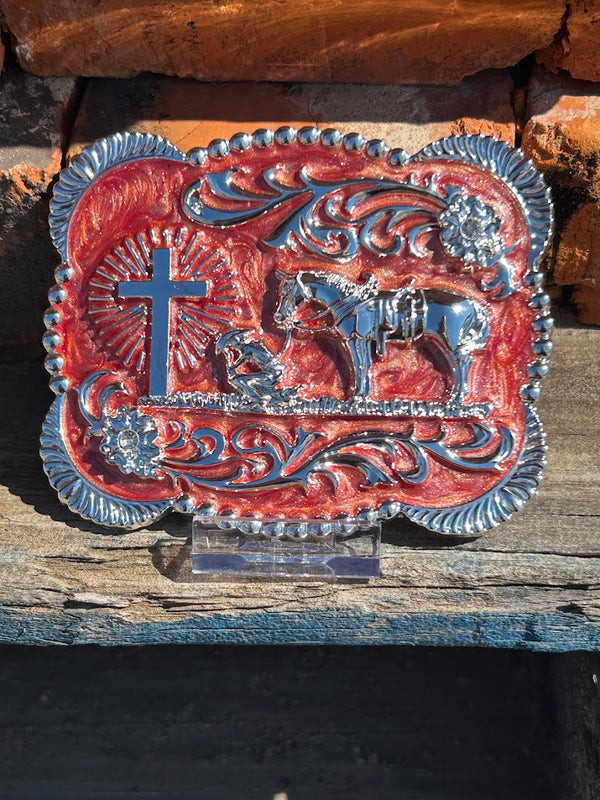 Silver Praying Cowboy belt buckle on a Clay background. 