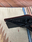 Black leather bi-fold wallet with Brown overlay and a Bull Rider Concho. Dual cash slot views showing zippered pocket. 