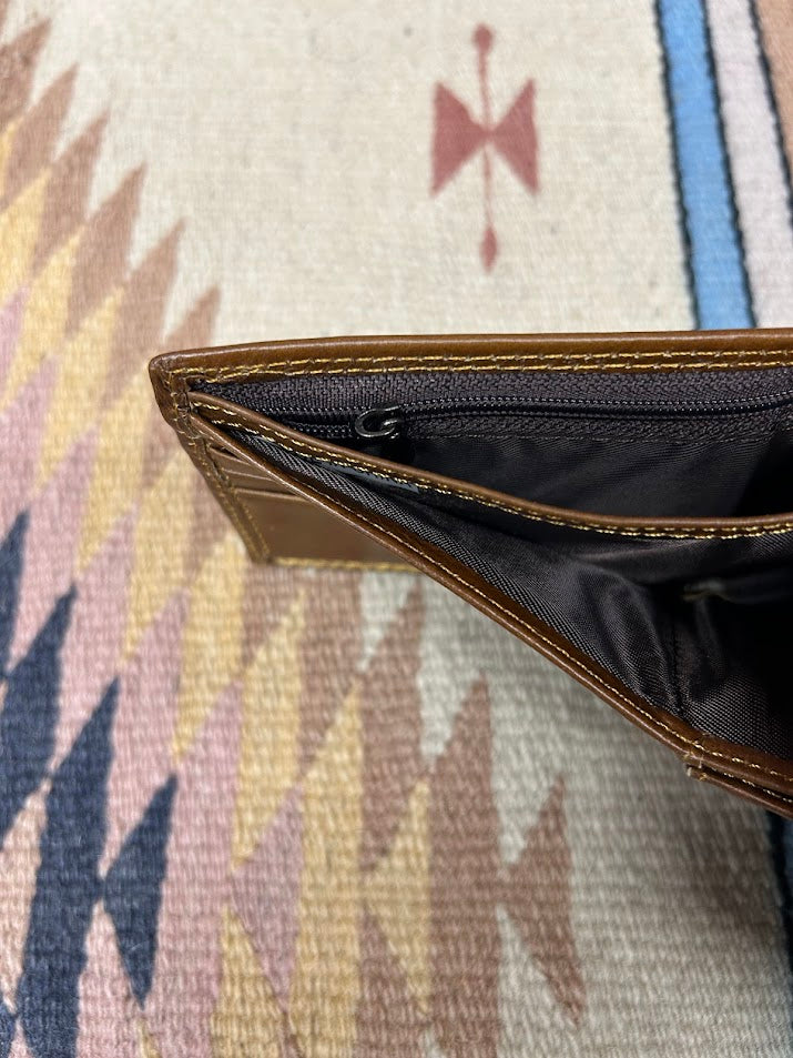 This genuine leather bifold wallet in Brown from Top Notch Accessories features 9 card slots and a ID window. Top view showing dual cash slots and zippered pocket. 