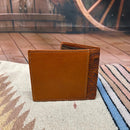 Light Brown tooled leather bifold wallet with a Turquoise inlay. Rear view showing additional card slot. 