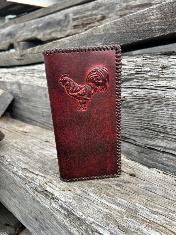 Brown leather checkbook wallet with a embossed rooster design and a whip stitched border. Front View