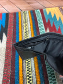Black leather trifold wallet  with a stich pattern on the top. Interior view of cash close showing zip close. 