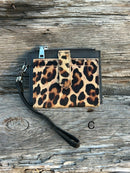 A leopard cowhide keychain wristlet wallet.  C