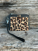 A leopard cowhide keychain wristlet wallet. D