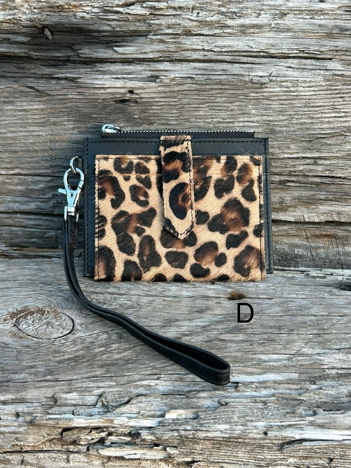 A leopard cowhide keychain wristlet wallet. D