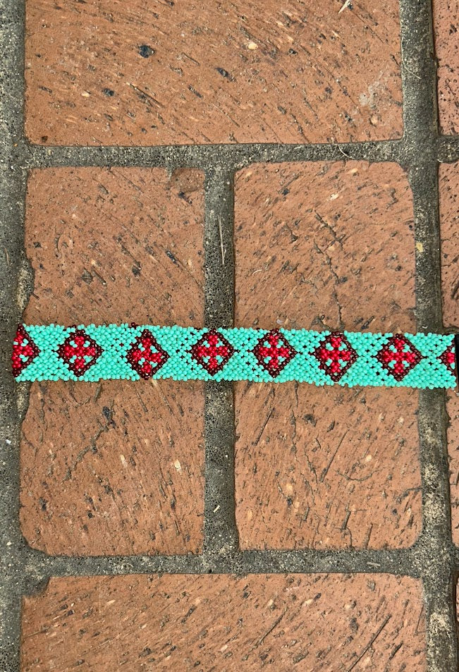 Teal beaded head or had band with Red Diamond accents. 
