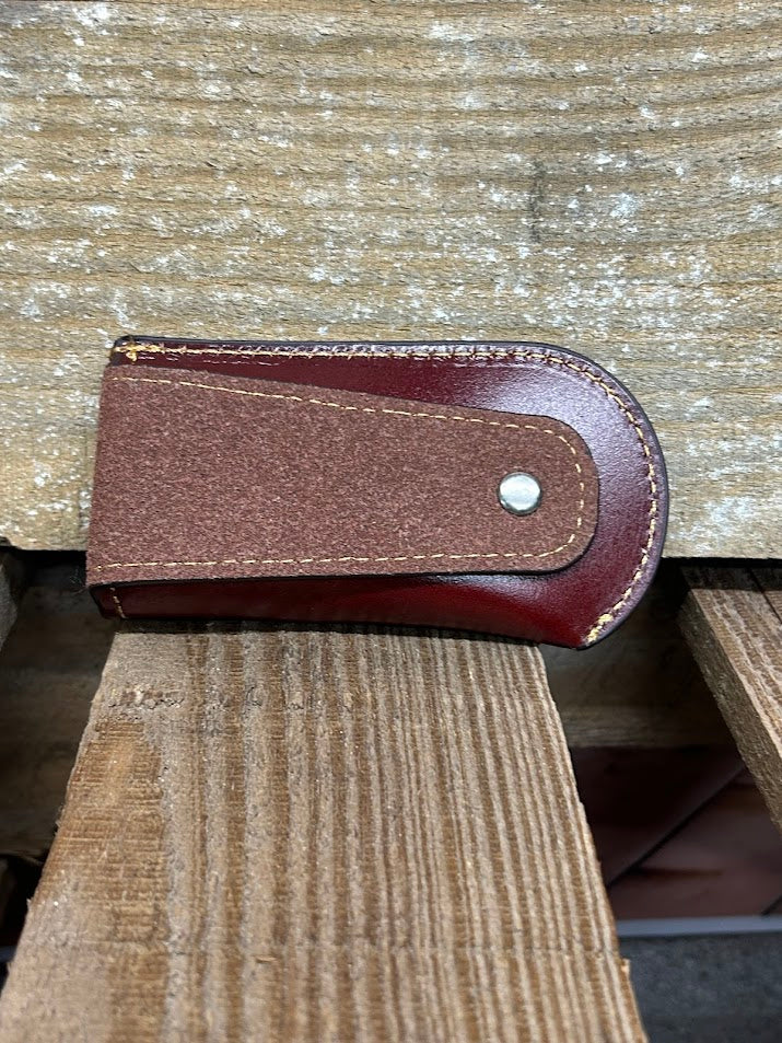 Brown knife sheath. Rear view showing leather belt loop. 