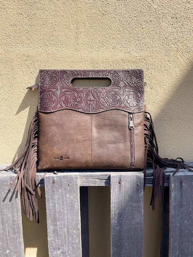 Cowhide and Coffee Brown tooled leather purse with fringe. This bag can be carried by the handle or the removable, adjustable strap. Rear view showing concealed carry pocket. 