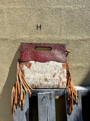 A cowhide and Brown tooled leather purse with fringe. Front View H