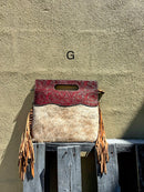 A cowhide and Brown tooled leather purse with fringe. Front View G