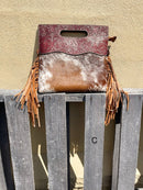 A cowhide and Brown tooled leather purse with fringe. Front View C