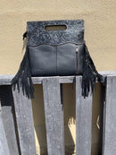 Black tooled leather and cowhide fringe bag. Rear view showing concealed carry zippered pocket. 
