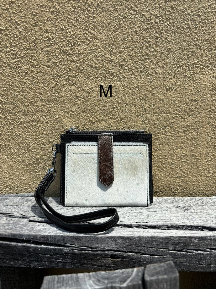 This black leather and cowhide wristlet wallet has six total card slots along with a zippered close pocket. Front View M