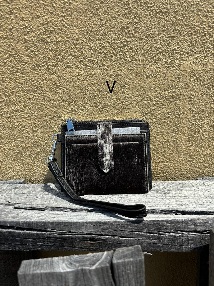 This black leather and cowhide wristlet wallet has six total card slots along with a zippered close pocket. Front View V