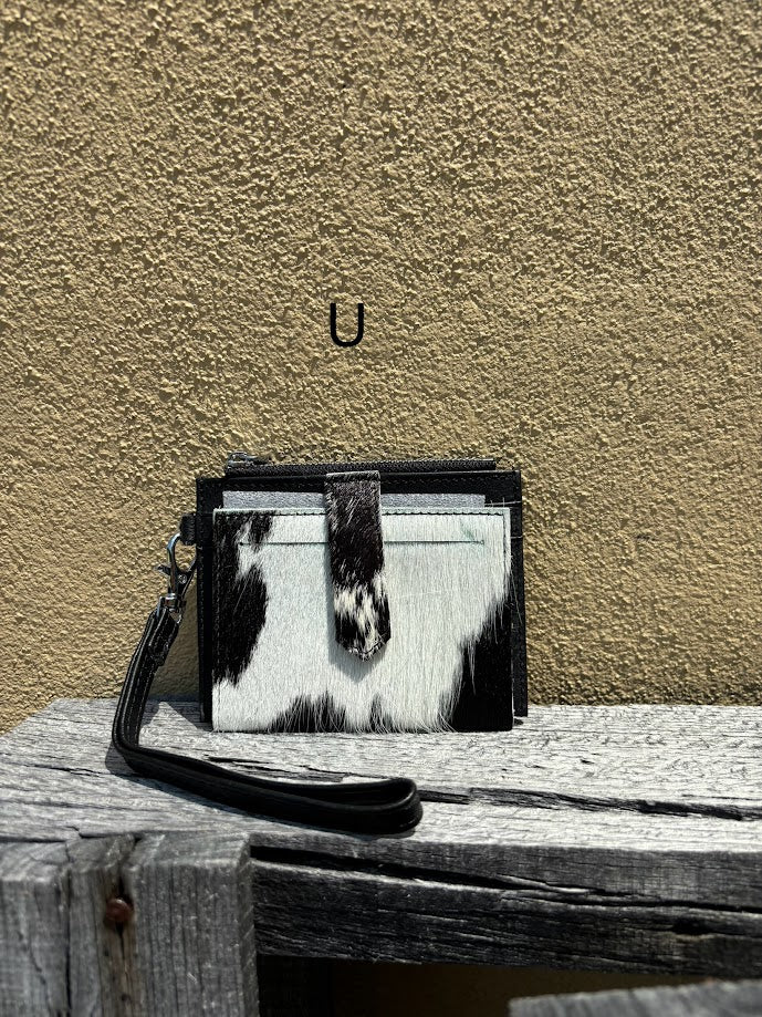 This black leather and cowhide wristlet wallet has six total card slots along with a zippered close pocket. Front View U