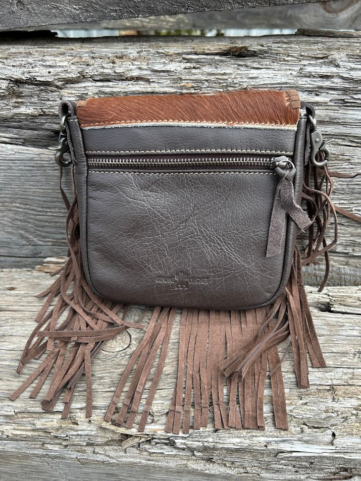 This cowhide and fringe crossbody bag in Coffee Brown leather has a removable and adjustable strap. Rear View 