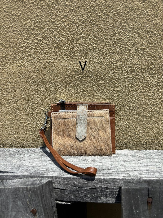 This Brown leather and cowhide wristlet wallet features six total card slots and a zippered pocket. Front View V