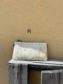 Cowhide wristlet purse with a solid Brown leather back and a zippered closure. It features a wristlet strap and and a adjustable removable shoulder strap. Front View R