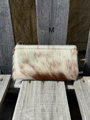Cowhide wristlet purse with a solid Brown leather back and a zippered closure. It features a wristlet strap and and a adjustable removable shoulder strap. Front View M