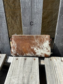 Cowhide wristlet purse with a solid Brown leather back and a zippered closure. It features a wristlet strap and and a adjustable removable shoulder strap. Front View  C