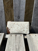 Cowhide wristlet purse with a solid Brown leather back and a zippered closure. It features a wristlet strap and and a adjustable removable shoulder strap. Front View Q