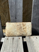 Cowhide wristlet purse with a solid Brown leather back and a zippered closure. It features a wristlet strap and and a adjustable removable shoulder strap. Front View L