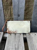 Cowhide wristlet purse with a solid Brown leather back and a zippered closure. It features a wristlet strap and and a adjustable removable shoulder strap. Front View B