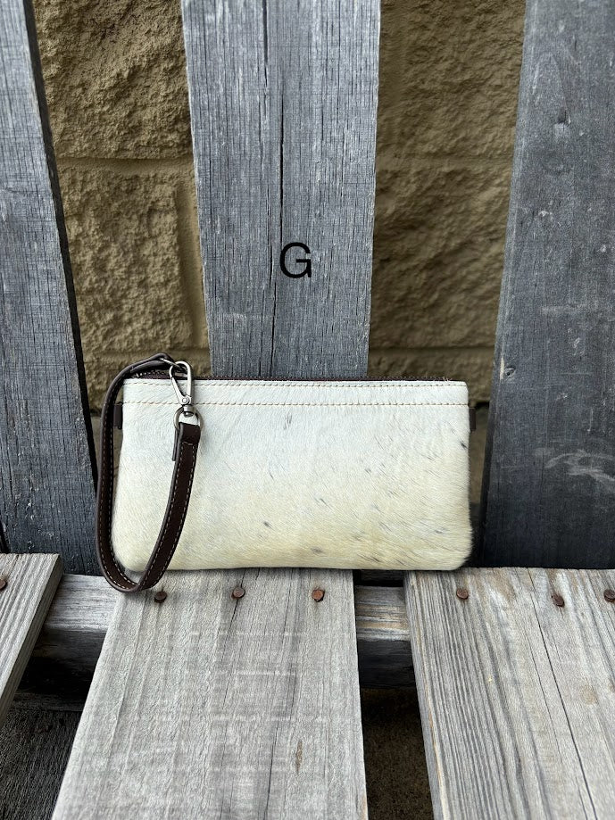 Cowhide wristlet purse in a Coffee Brown solid leather back and a zippered closure. It has a wristlet strap and a removable adjustable shoulder strap. Front View G