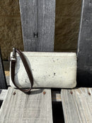 Cowhide wristlet purse in a Coffee Brown solid leather back and a zippered closure. It has a wristlet strap and a removable adjustable shoulder strap. Front View H