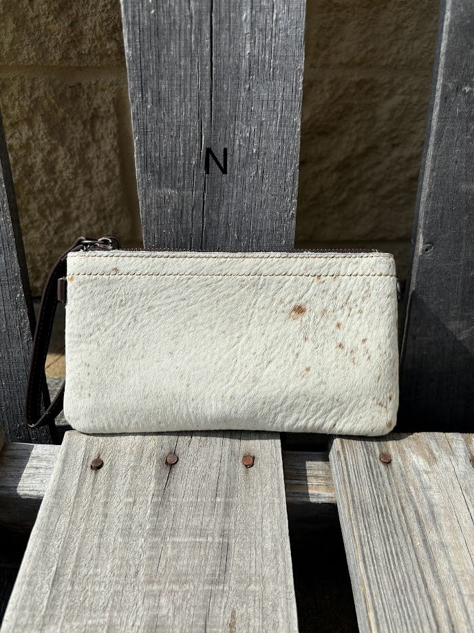 Cowhide wristlet purse in a Coffee Brown solid leather back and a zippered closure. It has a wristlet strap and a removable adjustable shoulder strap. Front View N