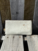 Cowhide wristlet purse in a Coffee Brown solid leather back and a zippered closure. It has a wristlet strap and a removable adjustable shoulder strap. Front View N